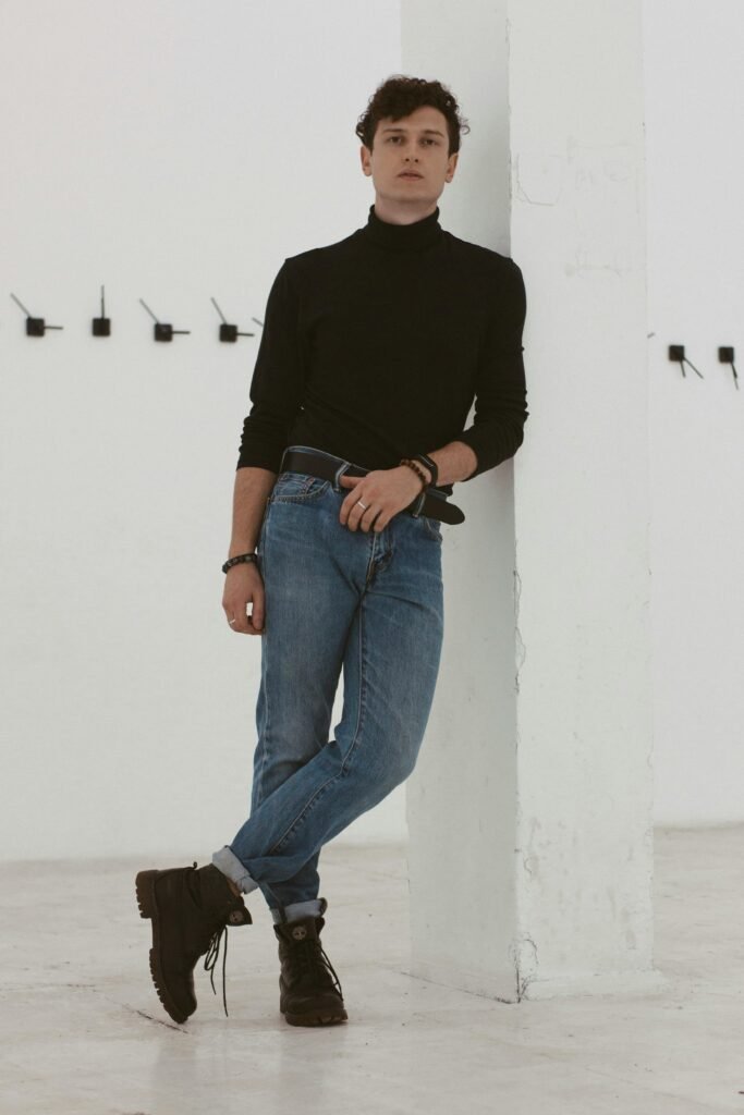 minimal turtleneck outfit men blue jeans black boots smart casual style