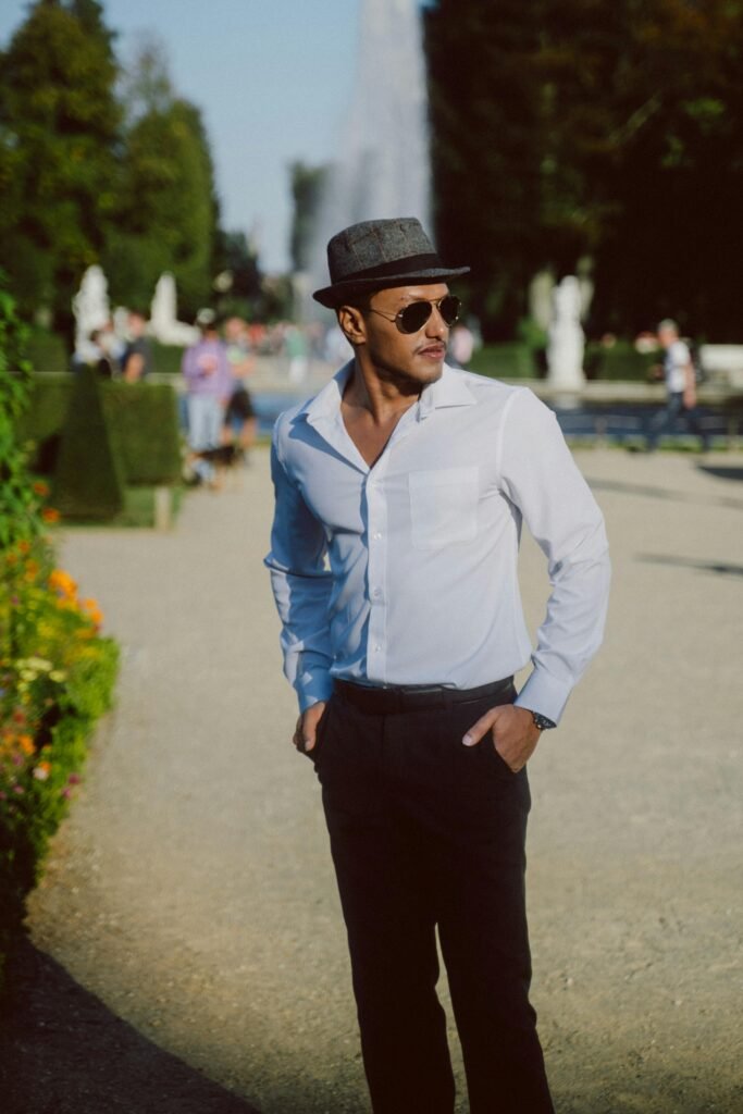 Minimal summer outfit for men with white open-collar shirt and tailored black trousers