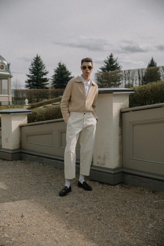 classic european minimal outfit men beige cardigan white pants
